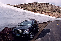 /images/133/2004-06-mtevans-jeep-drift.jpg - 01555: my Jeep next to 8ft tall snowbank at 13,000 ft … along Mt Evans road … June 2004 -- Mount Evans Road, Mt Evans, Colorado