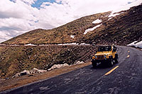/images/133/2004-06-mtevans-road-cars1.jpg - #01566: yellow Jeep Wrangler driving down from Mt Evans … June 2004 -- Mount Evans Road, Mt Evans, Colorado