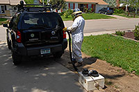 /images/133/2007-05-20-lake-bee-keeper2.jpg - #03791: Beekeeper Phil moving bees to a new home - A swarm of 2,500 bees with a queen moved into the back of my Xterra … May 2007 -- Lakewood, Colorado