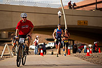 /images/133/2011-11-20-ironman-run-pros-d3s-2663.jpg - #09820: 06:45:04 - #34 Paul Amey [USA] (far right) in the lead (eventually 2nd) lapping #29 Douglas MacLean [USA] in Lap 2 - Ironman Arizona 2011 … November 2011 -- Tempe, Arizona