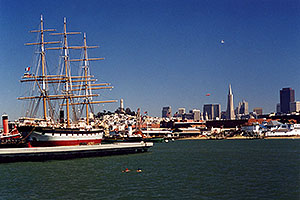 Ship docked in San Francisco harbor â€¦ people swimming in the Bay â€¦ Seagull and Zeppelin in the air 