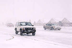 white Jeep Cherokee and cars in November snow, along Yosemite Road in Lone Tree
