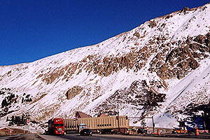 red semi truck leaving Eisenhower Tunnel (elev 11,013ft) and heading to Silverthorne 