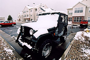 green Jeep Wrangler with late season snow (even April brings snowstorms in Denver suburbs)