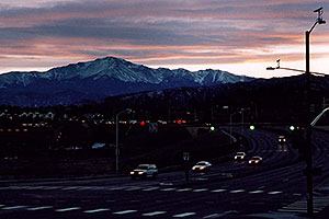 sunset above Pikes Peak â€¦ cars approaching I-25 from west on Woodmen Road