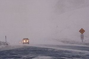 Jeep Wranger in snowstorm reaching top of Loveland Pass from Keystone side