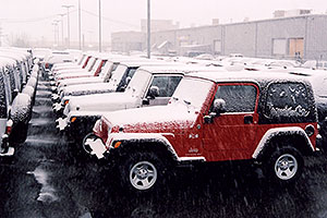 red Jeep Wrangler X and other snowy Jeep Wranglers at Lithia Jeep