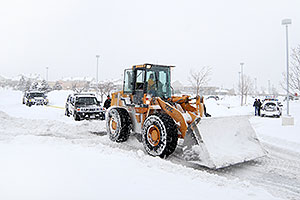 Front Loader Snowplow rescuing two Police Hummers