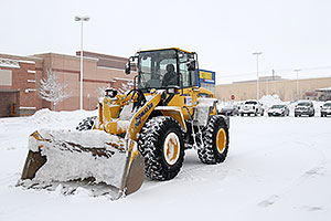 Komatsu Front Loader in front of Ultimate Electronics in Englewood, Colorado