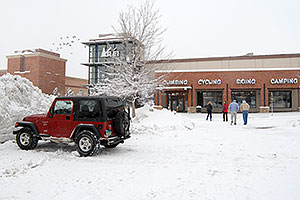 red Jeep Wrangler and people walking to REI #61 in Englewood, Colorado
