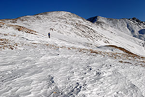 skier walking up east face of Loveland Pass