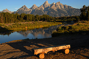 Bench in front of Snake River with Tetons in the morning