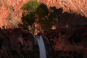 People next to Mooney Falls in the afternoon - 210 ft drop (64 meters)