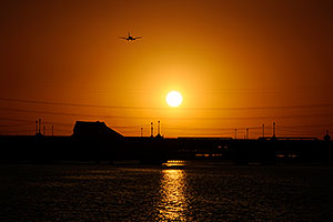 Plane flying into the sun at Tempe Town Lake