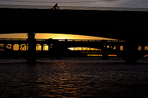 Cyclist on Mill Road bridge over Tempe Town Lake