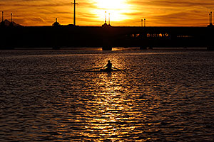 Sculler at sunset on Mill Road bridge over Tempe Town Lake