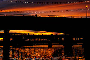Runner at sunset on Mill Road bridge over Tempe Town Lake