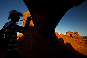 Photographer silhouette and view of Delicate Arch in Arches National Park