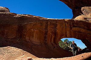 People at Double O Arch in Arches National Park