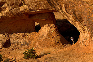 People in the morning at Partition Arch in Arches National Park