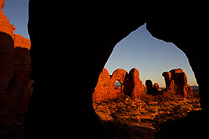 View of Double Arch through Cove Arch in Cove of Caves in Arches National Park