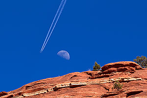 Plane flying near the moon and making tracks in Sedona