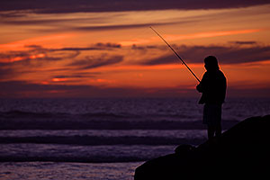 Fishing at sunset by Carlsbad, California