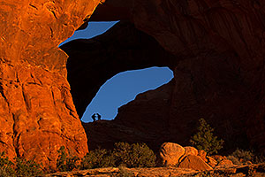 People silhouettes at Double Arch in Arches National Park
