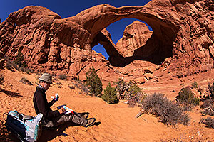Artist drawing at Double Arch in Arches National Park