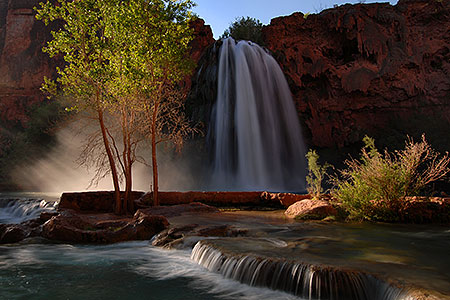 Morning sun rays shining at the mist of Havasu Falls - 120 ft drop (37 meters) 