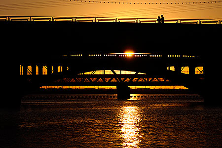 People at Mill Road bridge at sunset at Tempe Town Lake 